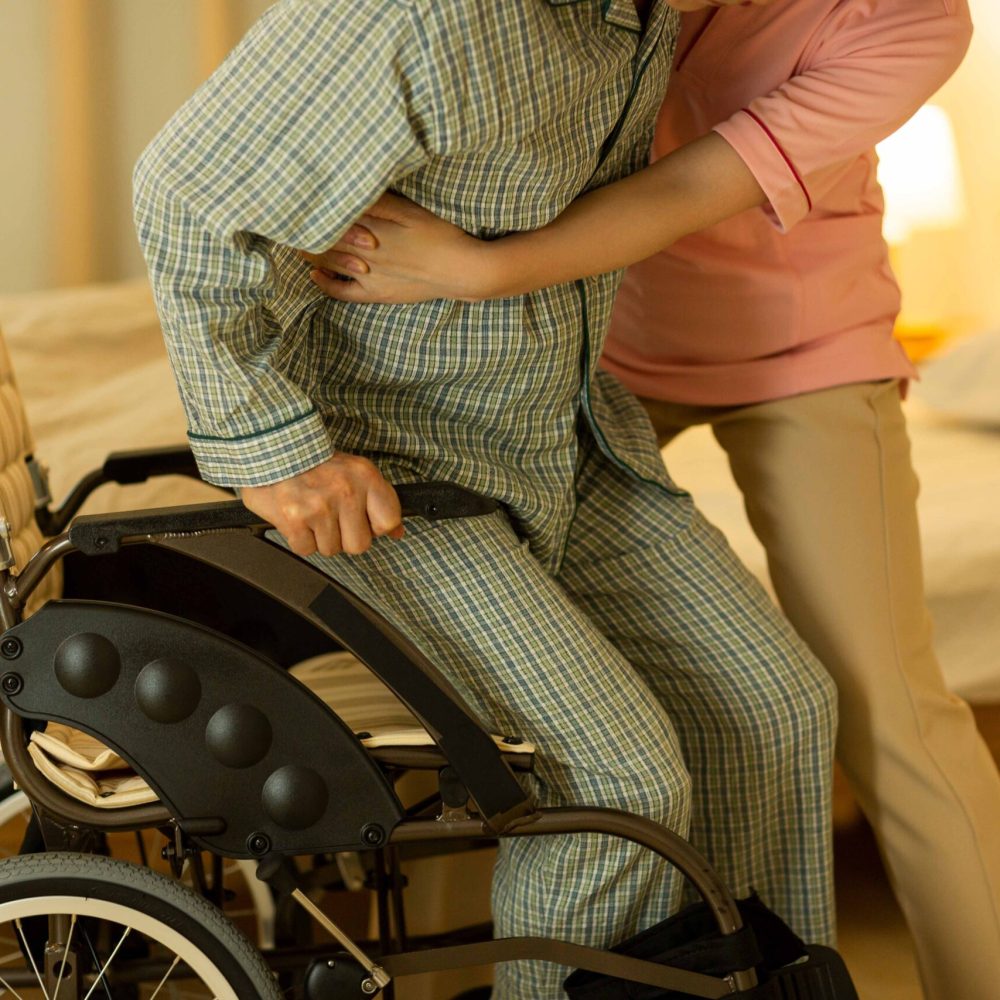 Senior man being cared by a female caregiver